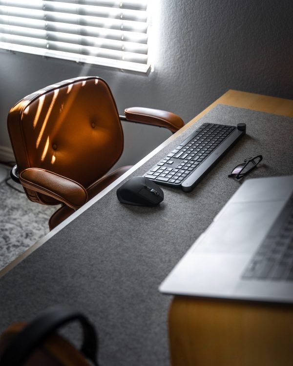 Closing down a company: Empty chair at office desk. keyboard and mouse on desk