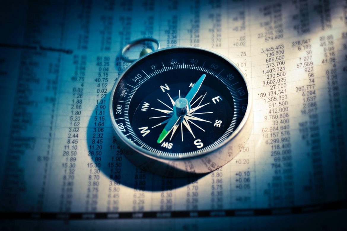 Investing in platinum: compass placed on a spreadsheet