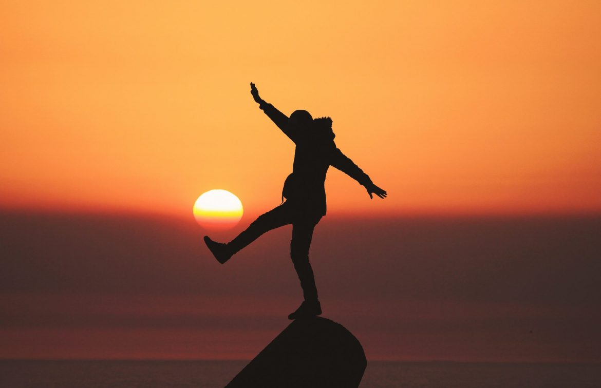 Block Energy (BLOE): Investment review: Boy perched on rock pretending to kick a football