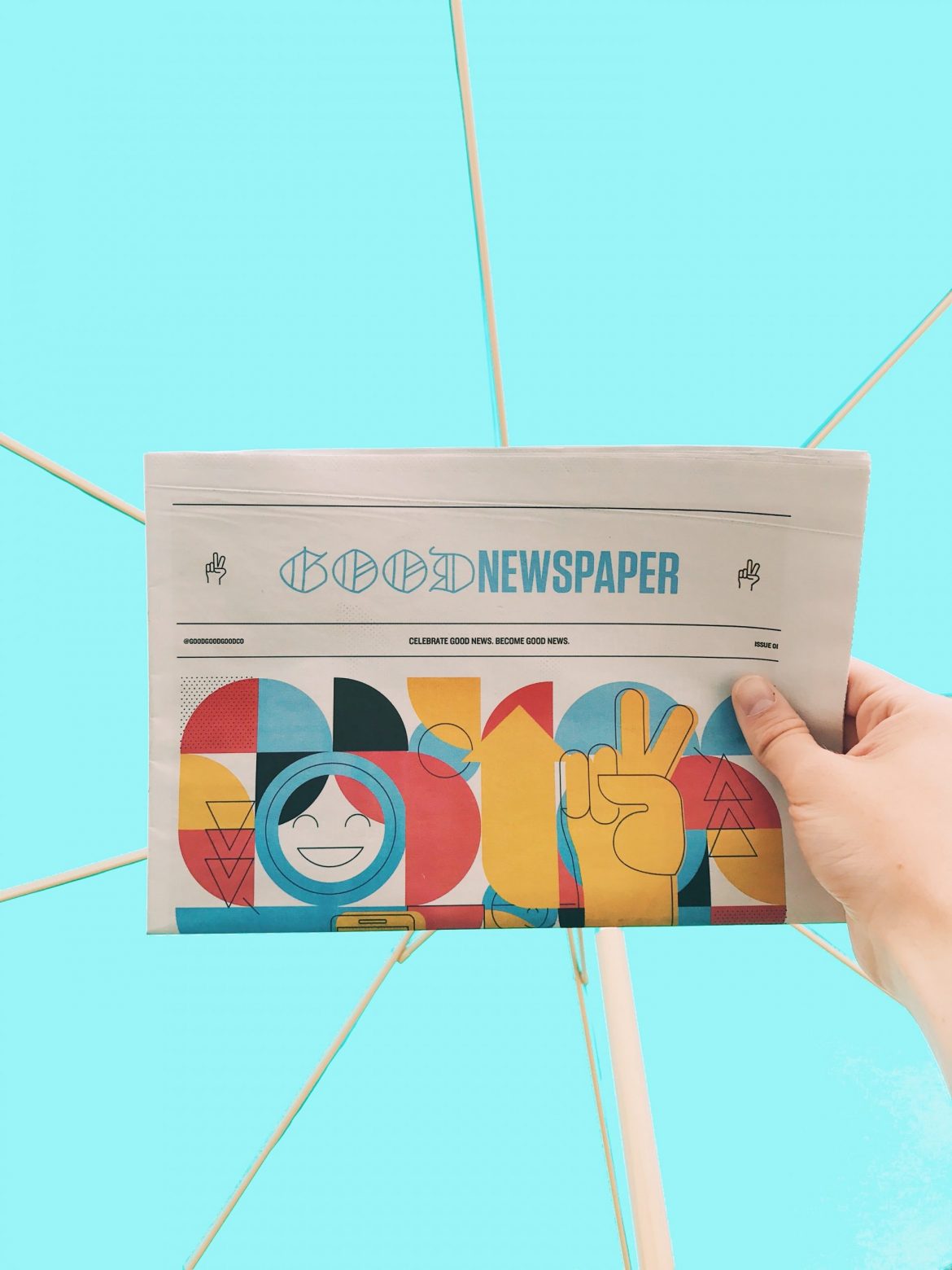 Investing in shares: Newspaper titled "Good news" being held up against a blue background