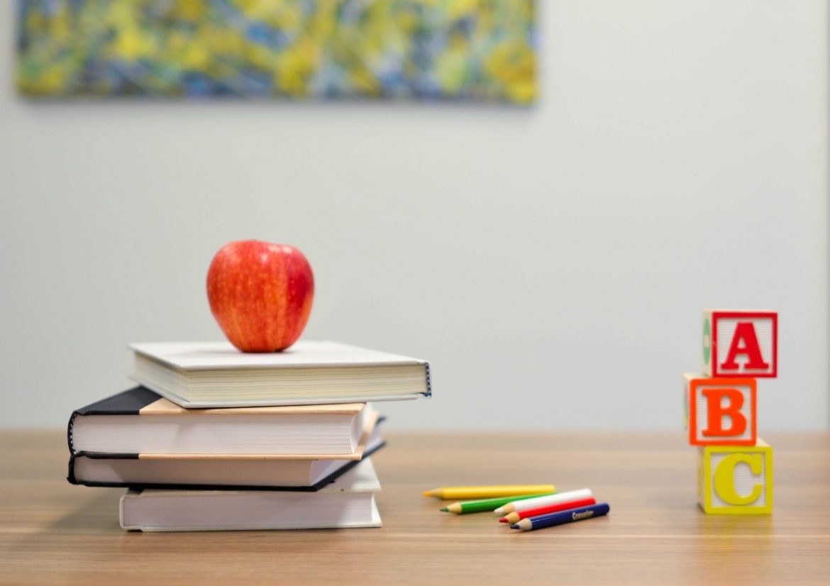 Malvern International Plc (MLVN): Series of books, pencils and letter learning blocks placed on a desk