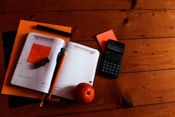 Financial planning calculators: Series of objects on a desk including a calculator and a diary