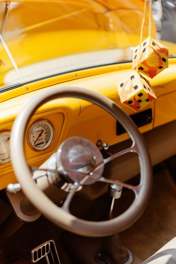 Business risks: Inside of a car with a pair of dice handing from the rear view mirror