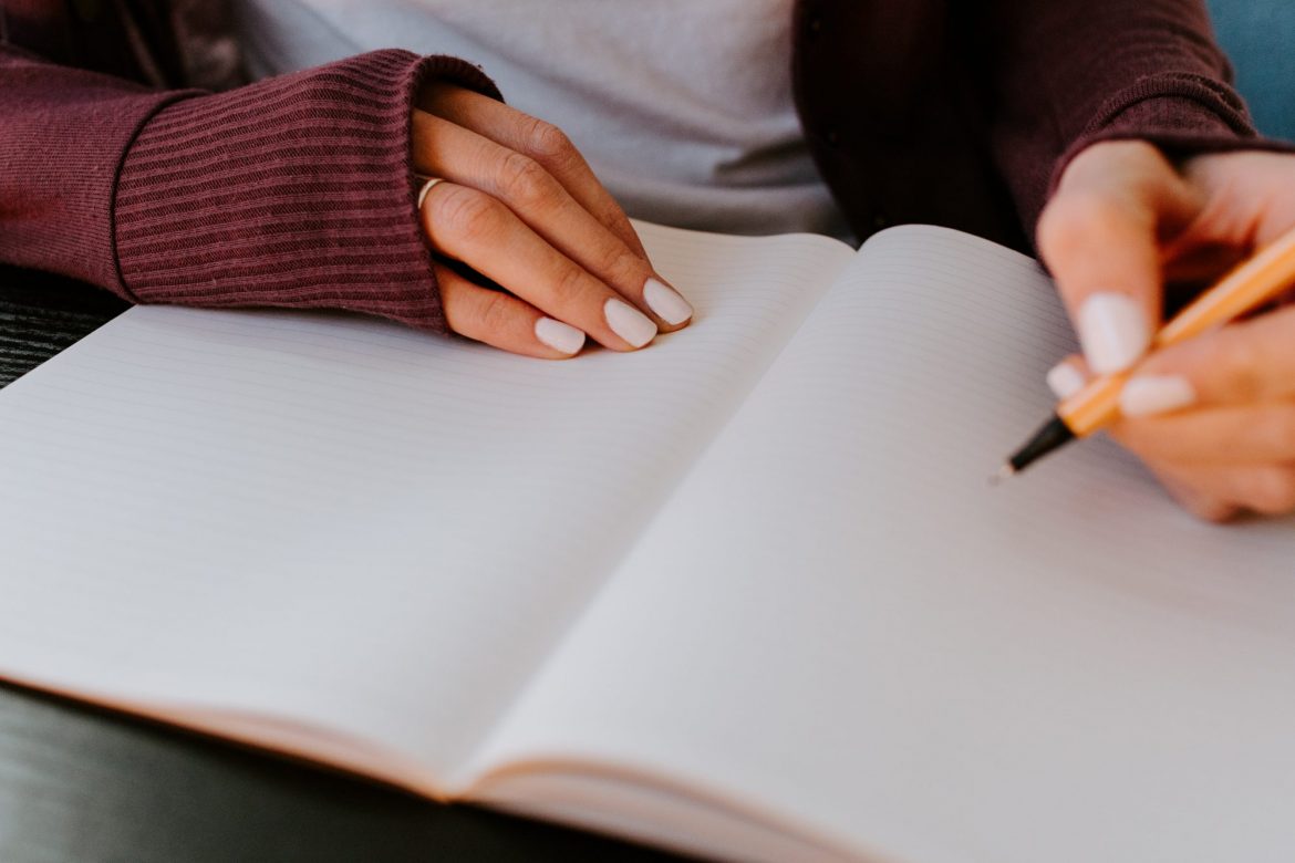 Promissory note Victoria Oil and Gas (VOG): Girl sitting at a table writing up a journal