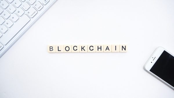 What is blockchain technology: keyboard and phone placed on a desk with the word