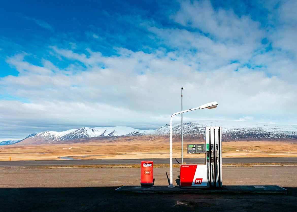 Investing in oil: Isolated petrol station pictured against a snow capped mountain in the background