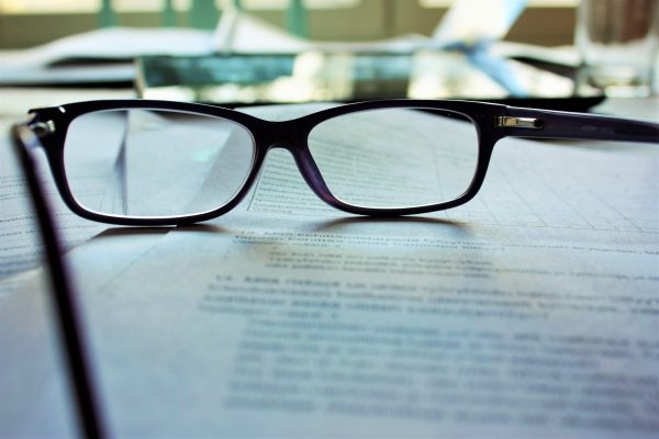 Convertible bonds: Close up image of reading glasses resting on the page of an open book