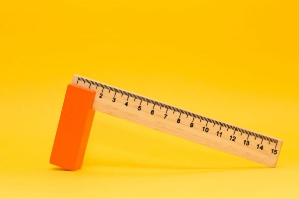 Investor types:A measuring ruler set against a yellow background